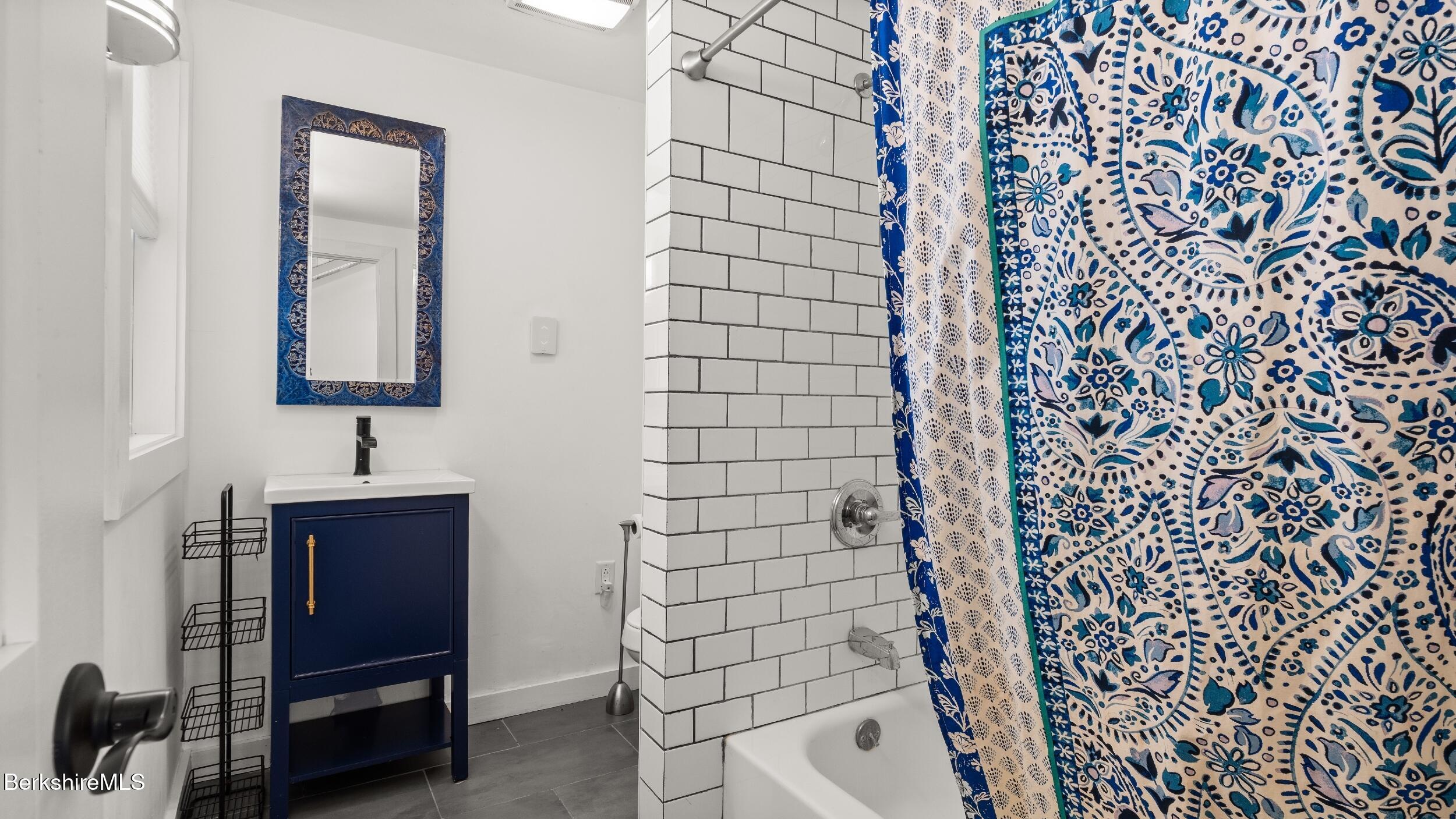 418 Monterey Road Great Barrington, MA 01230 - Photo 18 of 28 a bathroom with a shower curtain and a sink