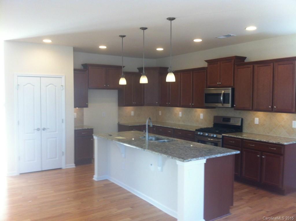 4286 Perth Road, Unit 316 Indian Land, SC 29707 - Photo 2 of 10 a kitchen with stainless steel appliances granite countertop a sink a stove and a refrigerator