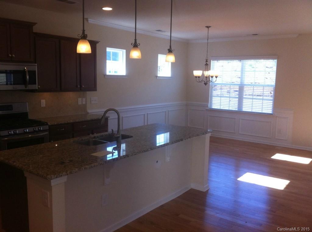 4286 Perth Road, Unit 316 Indian Land, SC 29707 - Photo 3 of 10 a kitchen with kitchen island a large counter space a sink and a window