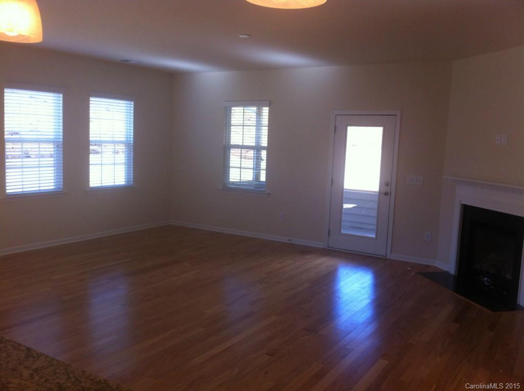 4286 Perth Road, Unit 316 Indian Land, SC 29707 - Photo 4 of 10 a view of an empty room with wooden floor and a window