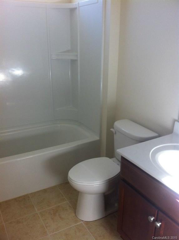4286 Perth Road, Unit 316 Indian Land, SC 29707 - Photo 9 of 10 a white toilet sitting next to a bath tub