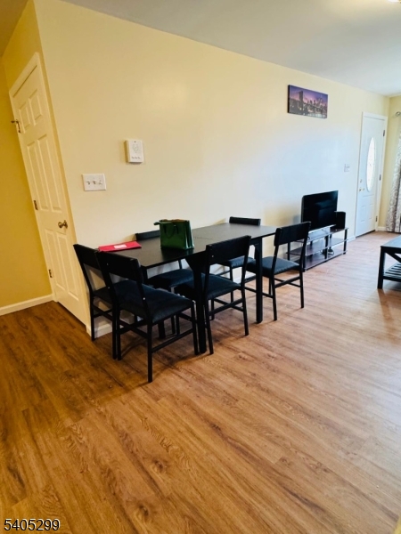 1049 Lafayette Street Elizabeth, NJ 07201 - Photo 4 of 9 a view of a dining room with furniture and wooden floor