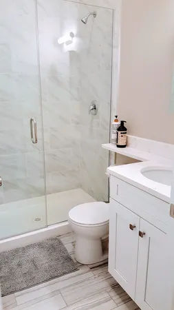 a bathroom with a sink toilet and shower
