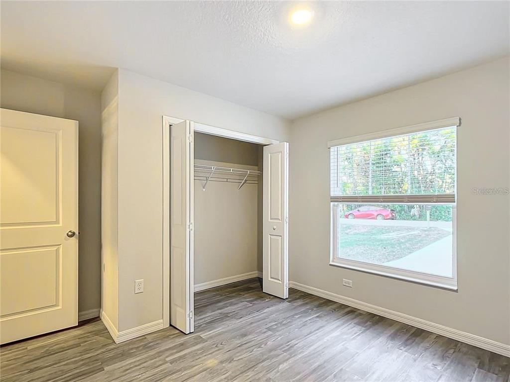 3070 East Odier Street Inverness, FL 34453 - Photo 5 of 14 wooden floor in an empty room with a window