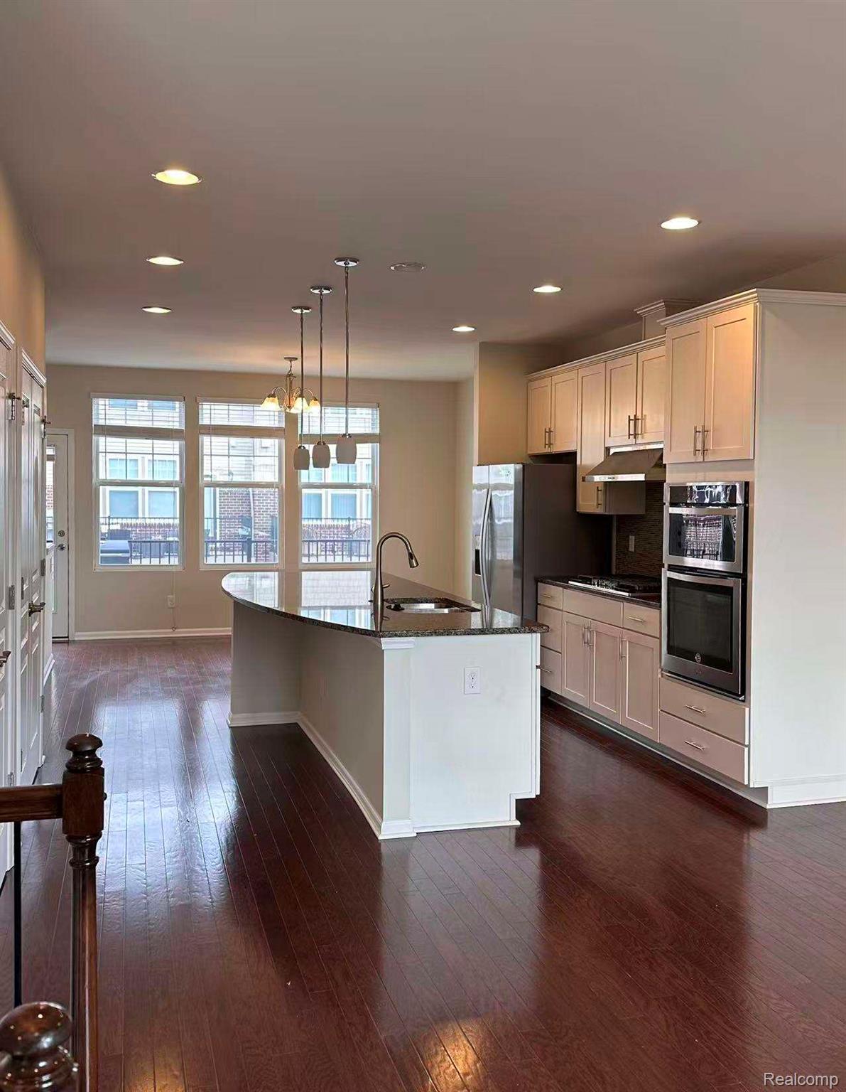 2578 Helmsdale Circle Rochester, MI 48307 - Photo 6 of 33 Kitchen featuring a large island with sink, white shaker cabinetry, stainless steel appliances, and recessed lighting