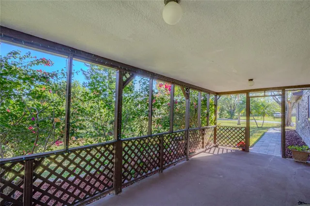 a view of a room with wooden floor and iron stairs