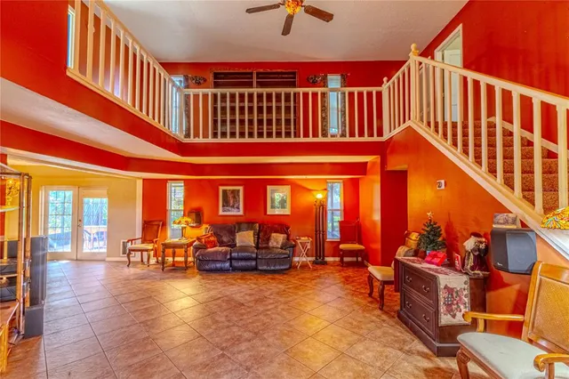 a view of swimming pool with a lounge chairs in front of a house