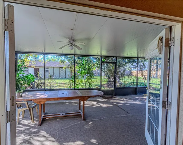 a view of a house with backyard and tree