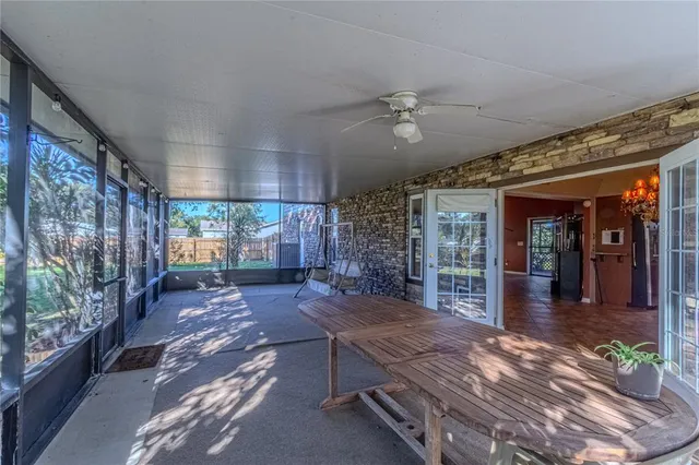 a view of a porch with a table and chairs