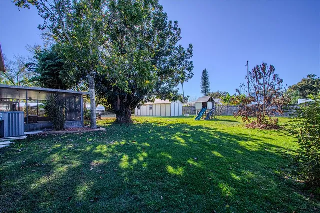 a view of an house with backyard space and garden