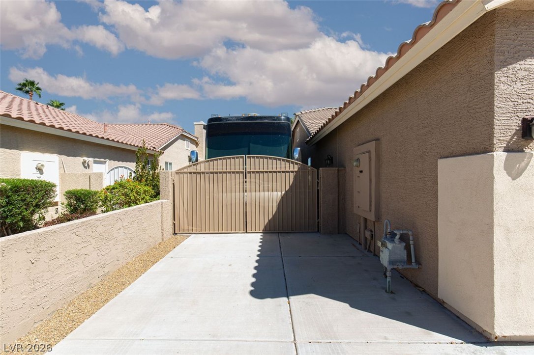 4670 Los Rancheros Avenue Las Vegas, NV 89129 - Photo 49 of 57 A spacious paved side driveway features a secure double gate with ample storage potential.