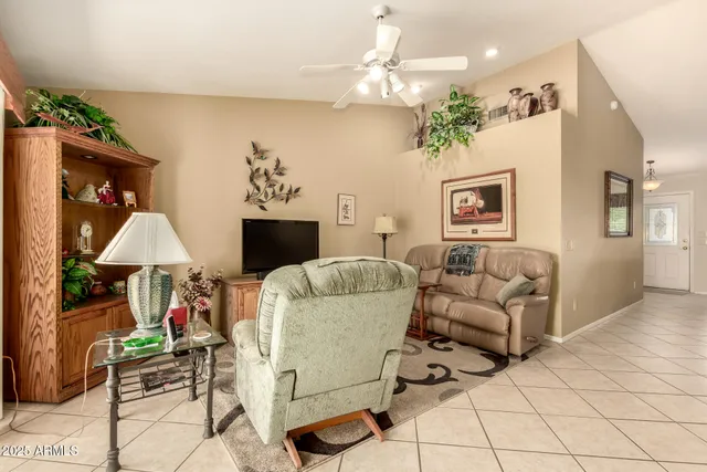 a living room with furniture a chandelier and a fireplace