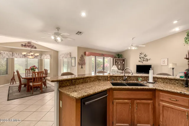 a open kitchen with granite countertop a sink and dishwasher a stove with wooden floor