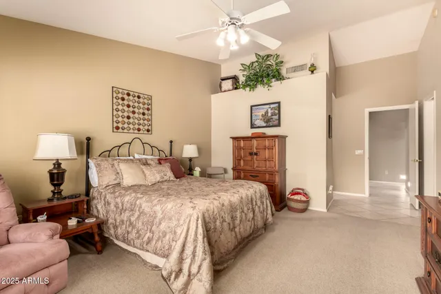 a bedroom with a bed and a lamp