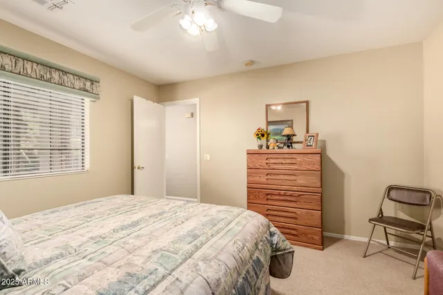 a bedroom with a bed and a chair