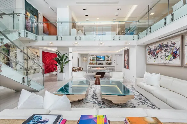 a living room with fireplace furniture and a rug