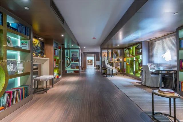 a view of a dining room with furniture a chandelier and wooden floor
