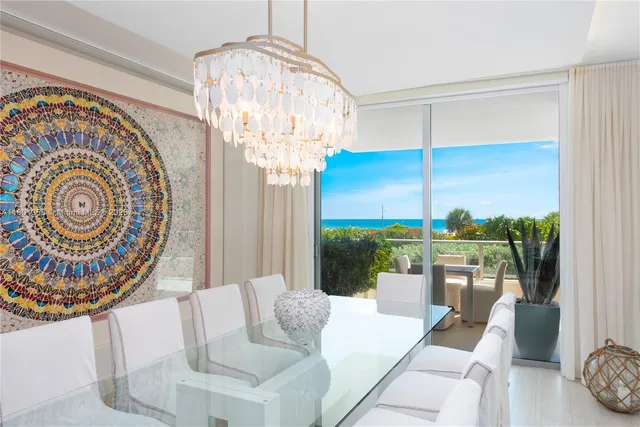 a view of a dining room with furniture wooden floor and chandelier