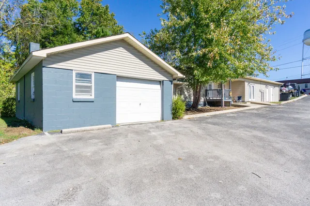 a view of a house with a yard and garage
