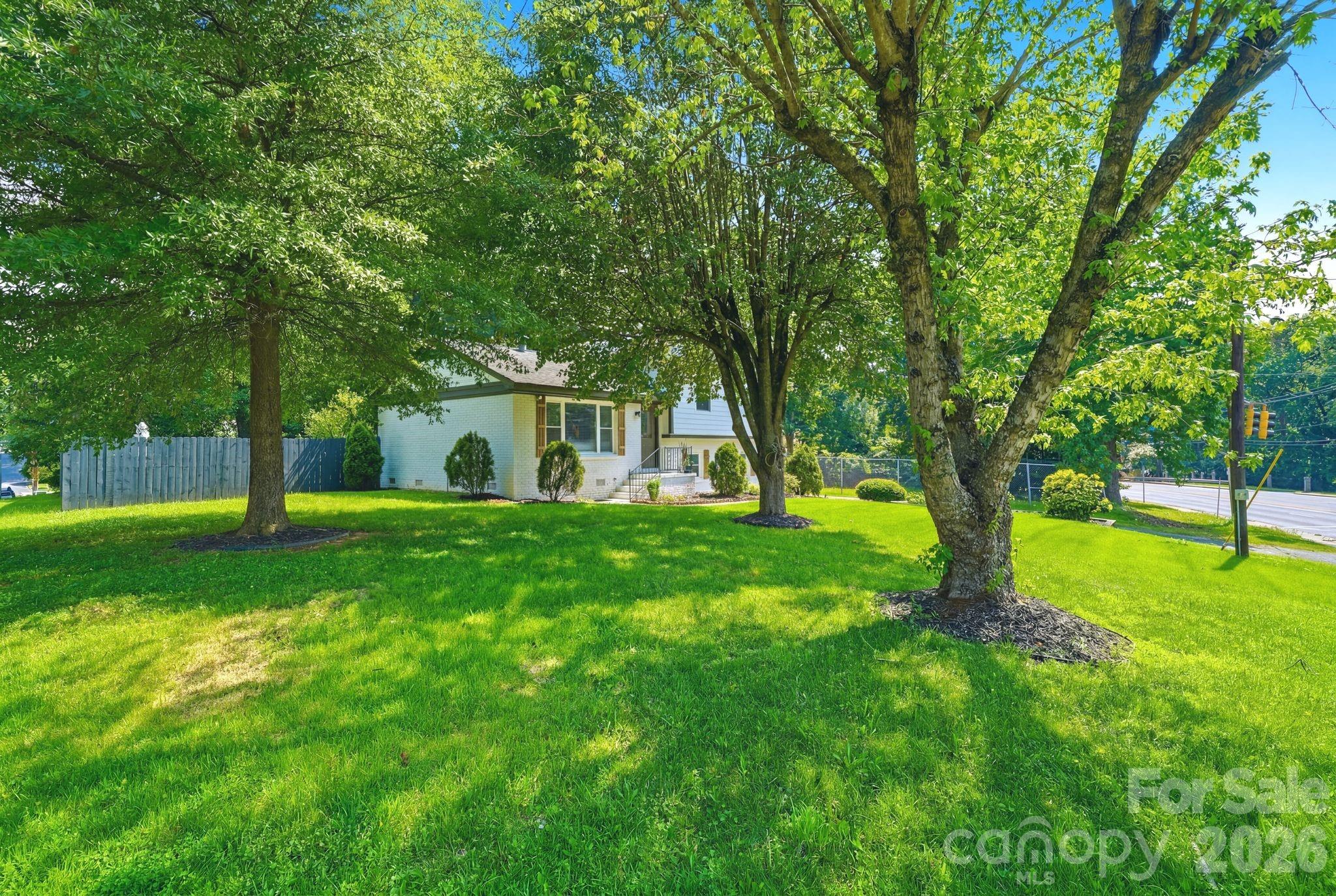 7552 Idlewild Road Charlotte, NC 28212 - Photo 40 of 40 a view of a house with a backyard and a tree
