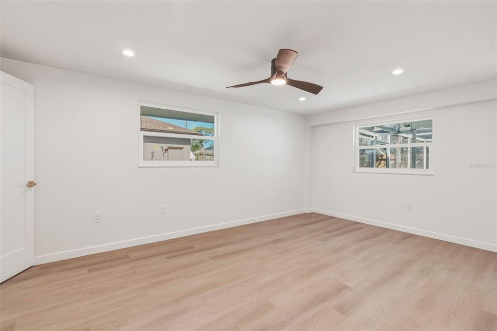 1330 Horizon Road Venice, FL 34293 - Photo 21 of 40 a view of an empty room with a window and wooden floor