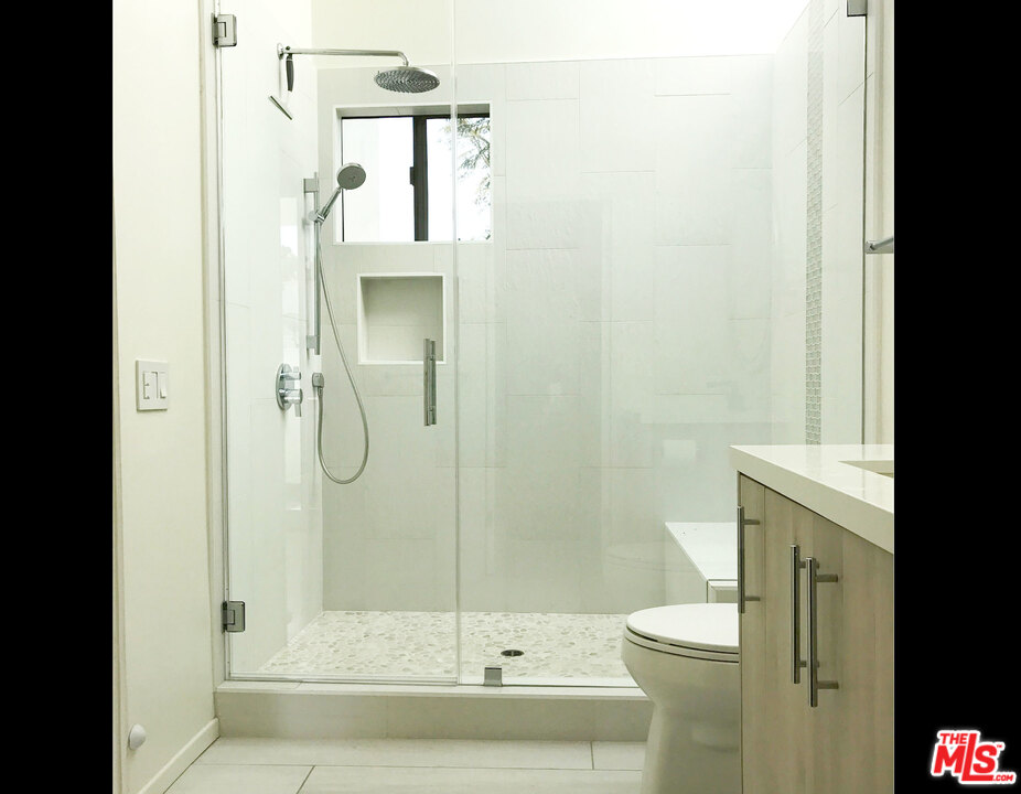 29221 Heathercliff Road, Unit 12 Malibu, CA 90265 - Photo 4 of 8 a bathroom with a sink a toilet and shower