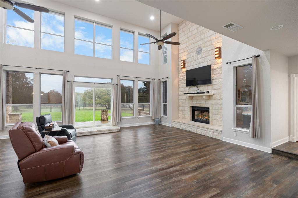 400 Indian Hills Road Gatesville, TX 76528 - Photo 8 of 38 a living room with furniture a flat screen tv and a fireplace