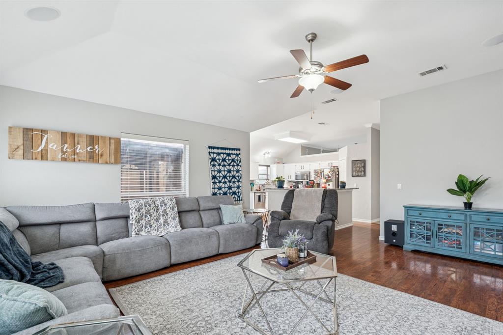 8016 Stern Street Frisco, TX 75035 - Photo 3 of 20 Large open living room area with fire place and surround sound speakers in ceiling.