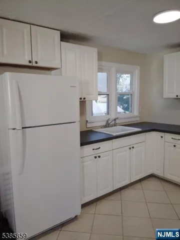 a kitchen with a sink and a refrigerator