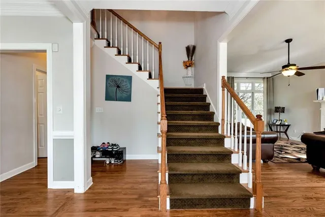 a view of entryway and hall with wooden floor