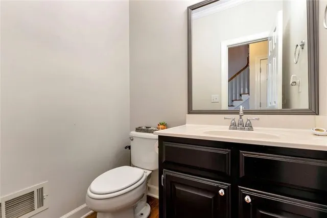 a kitchen with stainless steel appliances granite countertop a stove a sink dishwasher a refrigerator and a microwave oven with wooden floor