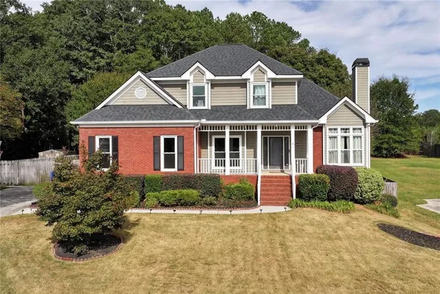 a front view of a house with garden