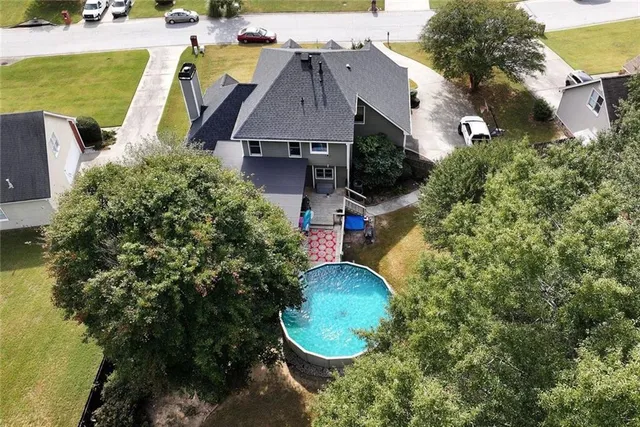 an aerial view of a house with garden space and sitting space