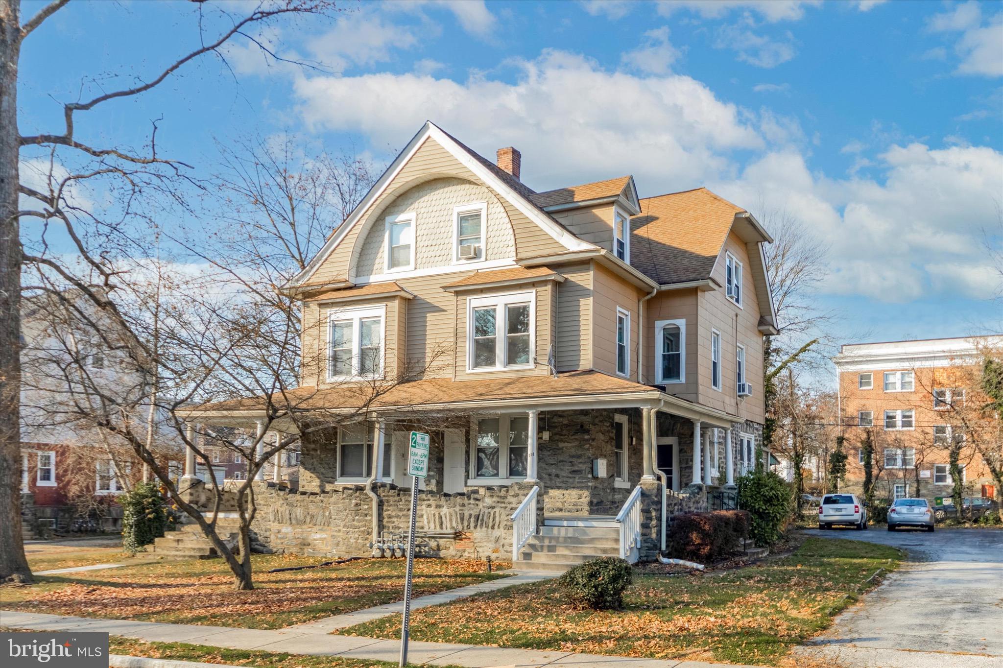 a front view of a residential apartment building with a yard