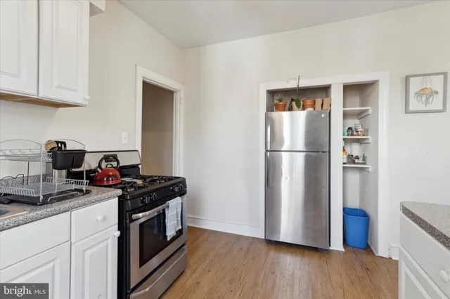 a kitchen with a refrigerator and a sink
