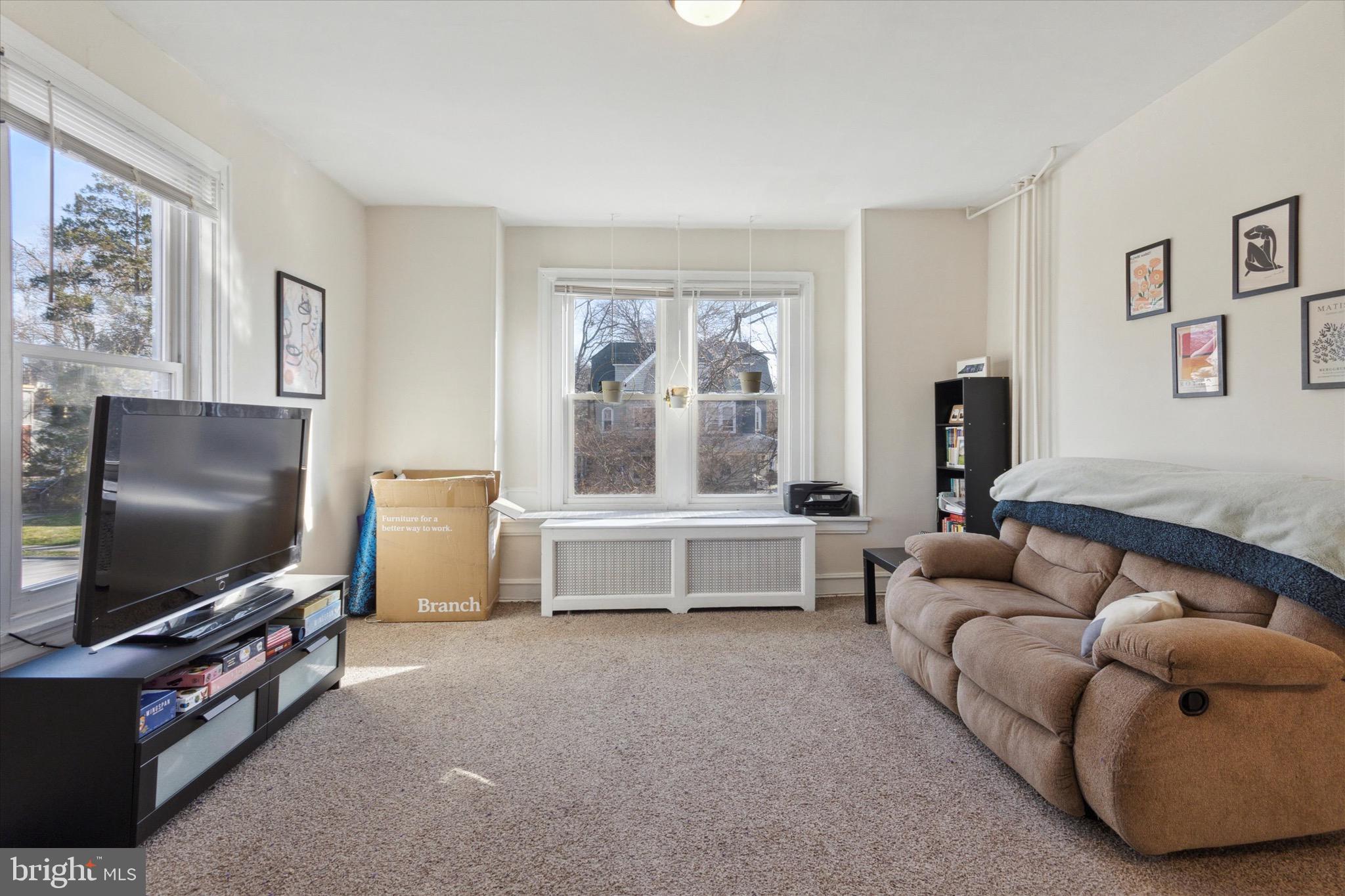 118 Walnut Avenue, Unit 2 Ardmore, PA 19003 - Photo 2 of 15 a living room with furniture and a flat screen tv