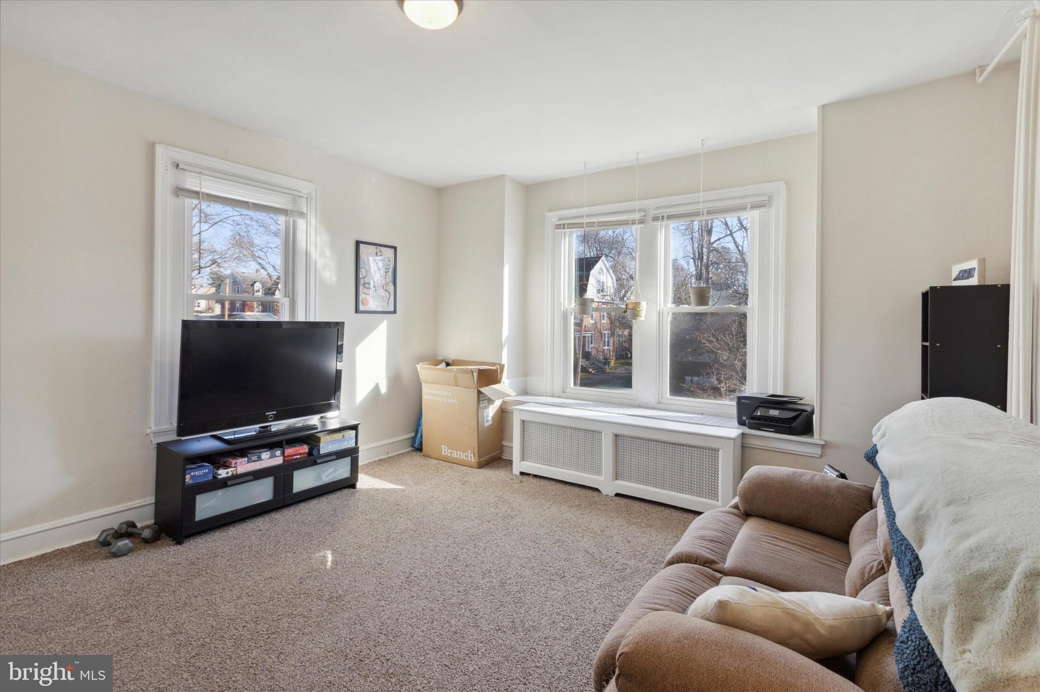 118 Walnut Avenue, Unit 2 Ardmore, PA 19003 - Photo 3 of 15 a living room with furniture and a flat screen tv