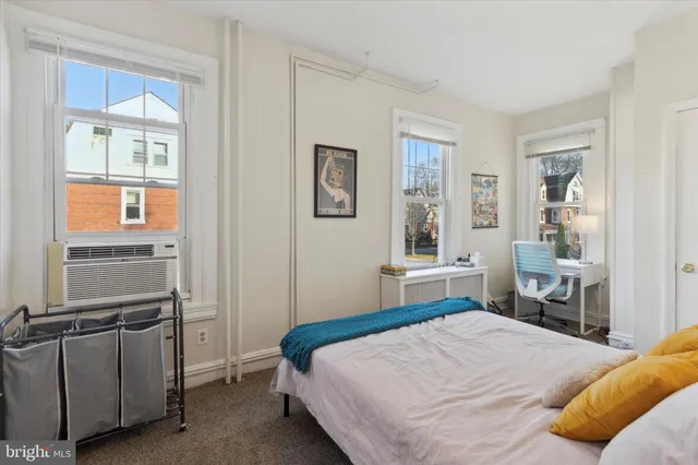 a bedroom with a bed and a window