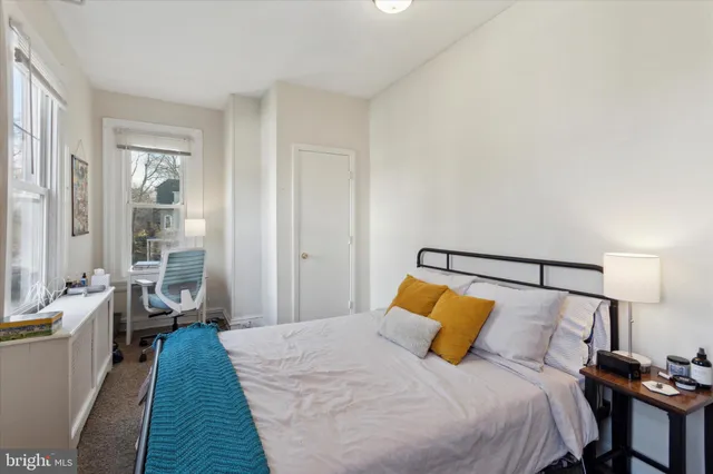 a bedroom with a bed and a lamp