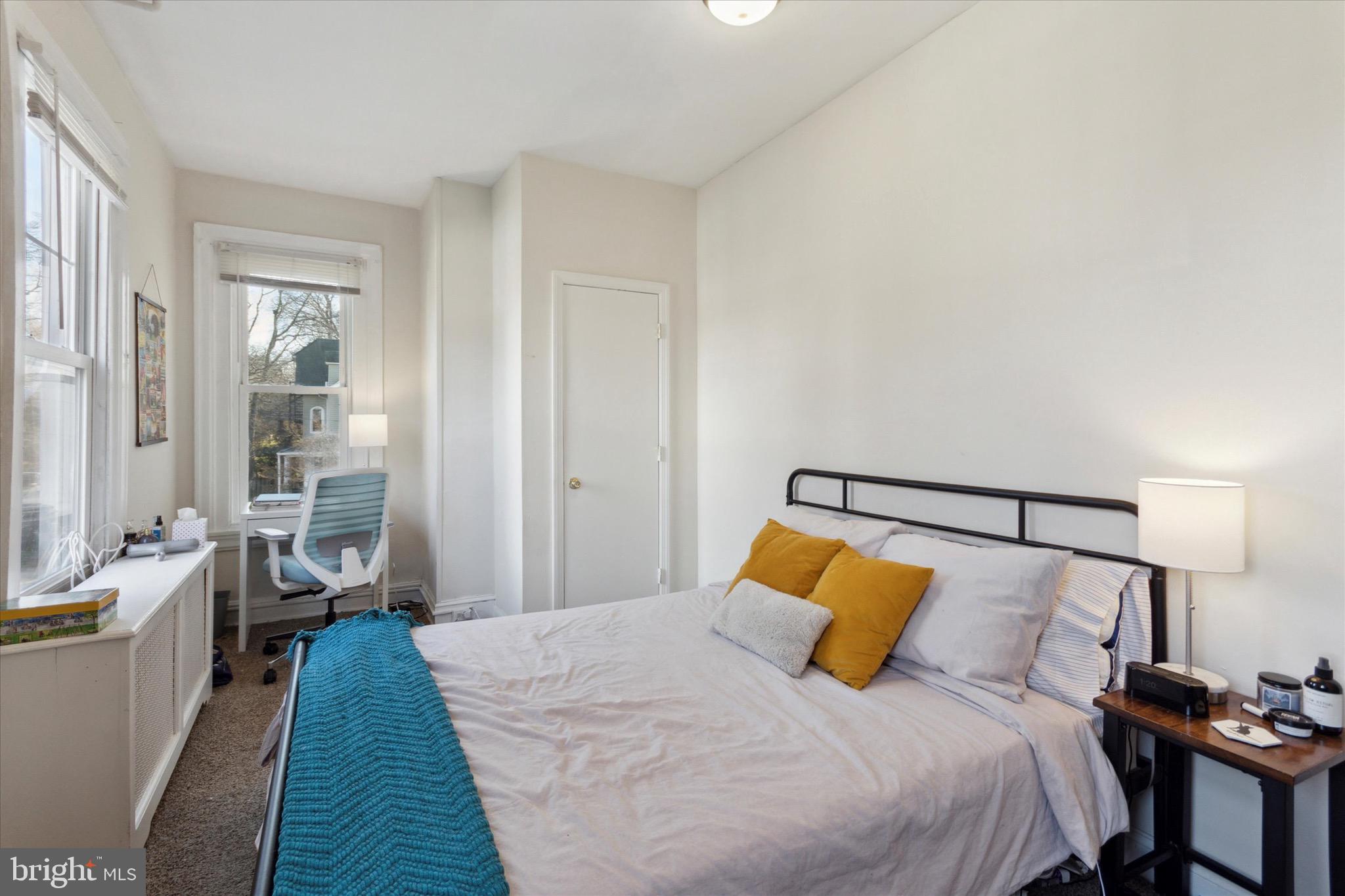 118 Walnut Avenue, Unit 2 Ardmore, PA 19003 - Photo 5 of 15 a bedroom with a bed and a lamp