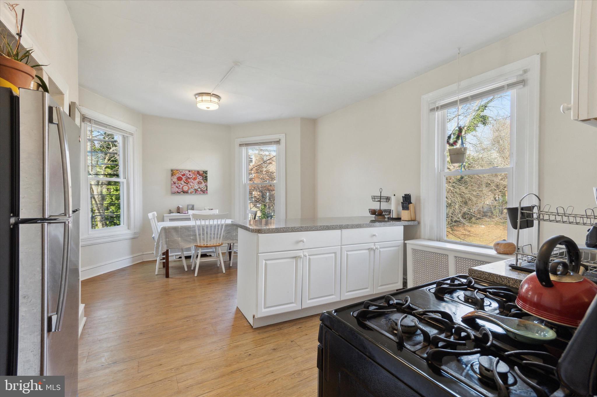 118 Walnut Avenue, Unit 2 Ardmore, PA 19003 - Photo 6 of 15 a kitchen with a stove a sink and a refrigerator