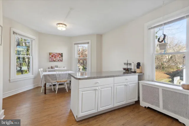 a kitchen with a sink cabinets and wooden floor