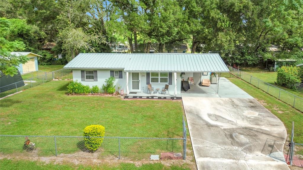 2301 Northeast 36th Street Ocala, FL 34479 - Photo 2 of 44 a front view of a house with a garden