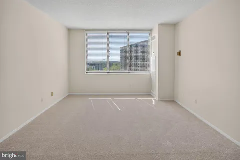 a view of an empty room and closet area