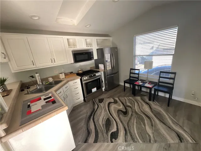 a kitchen with a sink stove and microwave