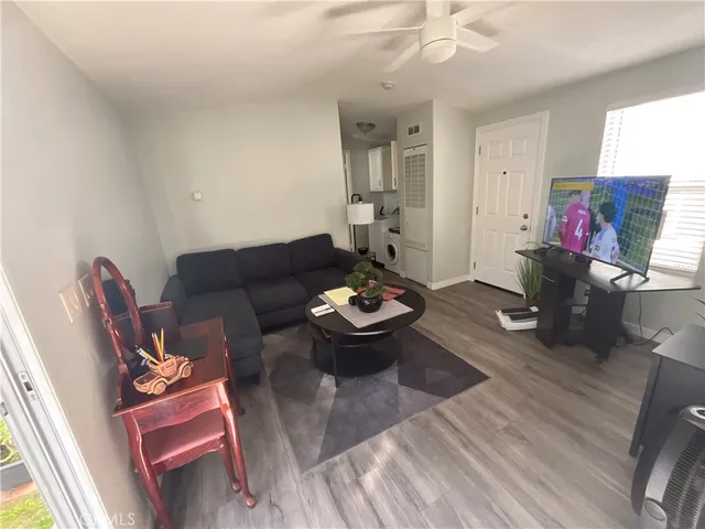 a living room with furniture and wooden floor