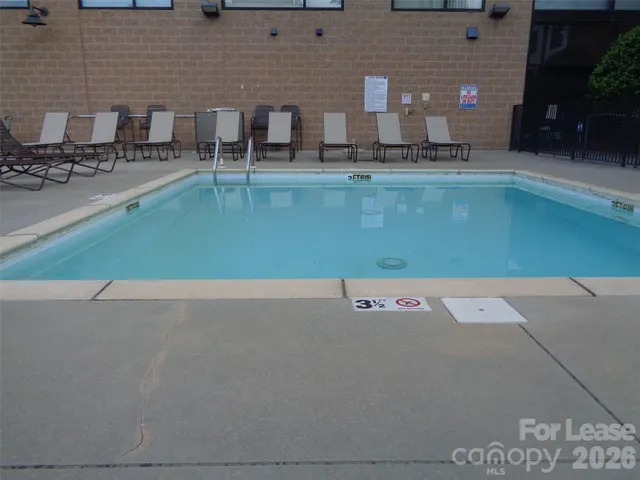 a view of a swimming pool and lounge chair