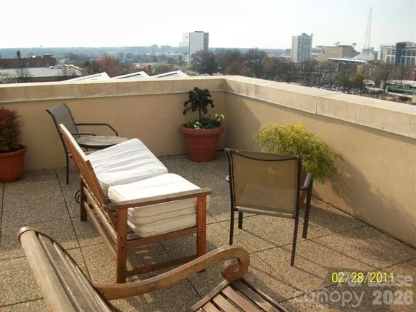 a terrace with outdoor seating and city view