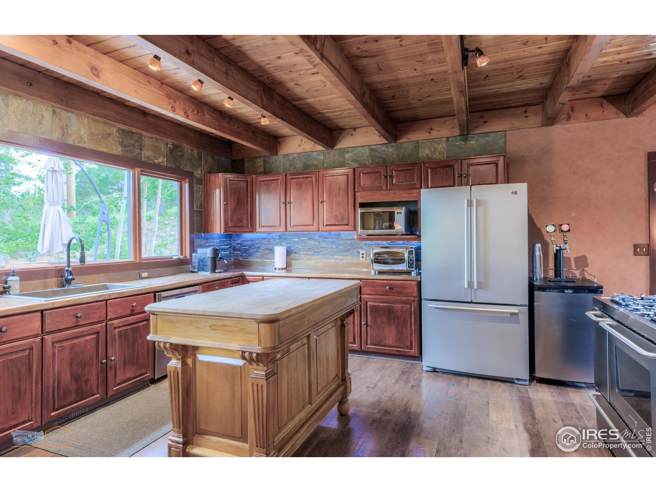 111 Puma Drive Boulder, CO 80302 - Photo 2 of 37 a kitchen with stainless steel appliances granite countertop a table chairs stove and refrigerator