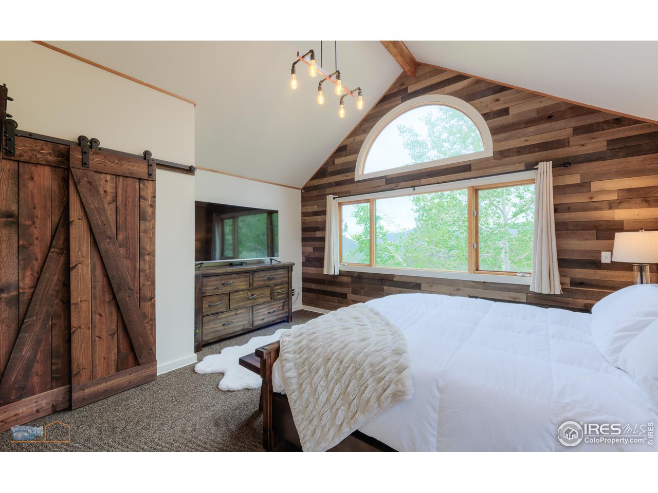 111 Puma Drive Boulder, CO 80302 - Photo 3 of 37 a living room with furniture a flat screen tv and a large window